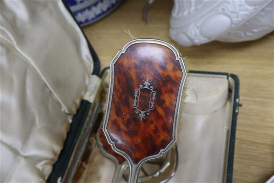 A cased plated and tortoiseshell brush set